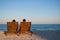 Romantic date girl and boyfriend sit on wooden deckchairs