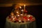 Romantic decoration table set with candles, glasses, roses and Teddy bear. dark warm tone.