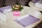 Romantic dining table with cute flower decor and purple napkins in cozy interior. Anniversary or event concept