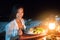 Romantic dinner on the beach at night at resort restaurant, Caribbean vacation luxury travel, Woman eating salad at