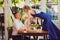 Romantic dinner. girl with glass of wine stands on table to kiss boyfriend