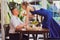 Romantic dinner. girl with glass of wine stands on table to kiss boyfriend