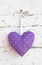 Romantic dotted heart shape hanging above white wooden surface o