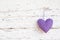 Romantic dotted heart shape hanging above white wooden surface o