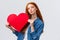 Romantic dreamy cute redhead teenager dreaming about giving boyfriend big red heart card to show her affection and love