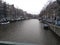 Romantic Dutch canals of Amsterdam on a gray day of winter haze