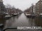 Romantic Dutch canals of Amsterdam on a gray day of winter haze