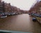 Romantic Dutch canals of Amsterdam on a gray day of winter haze