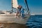 Romantic elderly couple embracing and kissing while relaxing on sail boat or yacht deck floating in a calm blue sea at