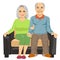 Romantic elderly couple sitting close together on a sofa