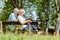 Romantic elderly couple sitting together on a bench in a tranquil day