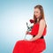 Romantic elegant woman in red dress with flower rose