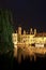 Romantic evening view of the canal, illuminated by old town lights and reflections in the water, Bruges, Belgium