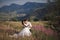 Romantic fairytale couple newlyweds kissing and embracing on a background of mountains