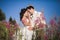 Romantic fairytale couple newlyweds kissing and embracing on a background of mountains