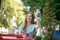 Romantic female with red lips sitting in open air cafe, waving her hand