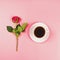 Romantic flat lay with a hot beverage and a red rose