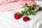 Romantic getaway with red roses on bed