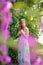 Romantic girl in garden with flower bougainvillea