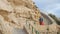 Romantic girl in red skirt walk down the stairs at the coast side