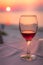 Romantic glass of wine on the beach at sunset