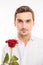 Romantic handsome man with a red rose