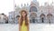 Romantic happy cheerful fashion girl in St Mark Square at Venice, Italy. Slow motion.