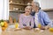 Romantic Happy Senior Couple Resting With Smartphone And Having Breakfast In Kitchen