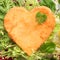 Romantic heart shaped fried golden schnitzel