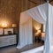 Romantic Hideaway: A master bedroom with soft, dreamy hues, flowing curtains, and a canopy bed adorned with fairy lights The roo