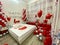 Romantic honeymoon bedroom decoration with a couple of swans kissing made from towels, balloons, and rose petals