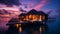 Romantic Hotels and Resorts on Maldives straw cabin evening blurred light blue sea water