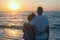 Romantic hugging couple enjoy the sunset on the beach