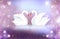 Romantic illustration of a pair of white swans on a blurred background with sparkles.