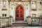 Romantic image of old french facade with reflection of spring blossoming cherry