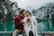 Romantic kiss of a couple of adults visiting an alpine lake at Braies Italy