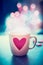 Romantic lifestyle with mug and heart at bokeh background, front view. Love symbol or Valentines day