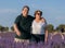 Romantic lifestyle portrait of senior hispanic couple happy and relaxed at lavender flowers field enjoying retirement and