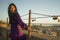 Romantic lifestyle portrait of young happy and beautiful Asian Korean woman on sunset at love padlocks attached to city railing