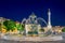 Romantic Lisbon street. Fountain at night in the center