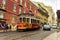 Romantic Lisbon street with the typical yellow tram, Portugal