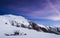 Romantic log cabin on top of snowy mountain photographed at night