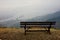 Romantic lonely bench on the top of the mountains