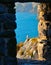 Romantic look at Portovenere on mediterranean sea, seagull on cliff through a historic medieval stone arch window. Liguria . Italy