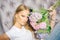 Romantic lovely young serene girl with bouquet of hydrangea flowers