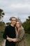 Romantic and Loving Young Adult Couple at the Park Looking At Nature and the Horizon for Portrait Pictures