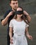 Romantic man blindfolding his woman with black ribbon. Love blind concept