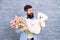 Romantic man with flowers and teddy bear. Romantic gift. Macho getting ready romantic date. Man wear blue tuxedo bow tie