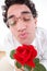 Romantic man with rose giving a kiss