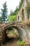 Romantic medieval ruins covered by green plants, abandoned city Mystras, Greece